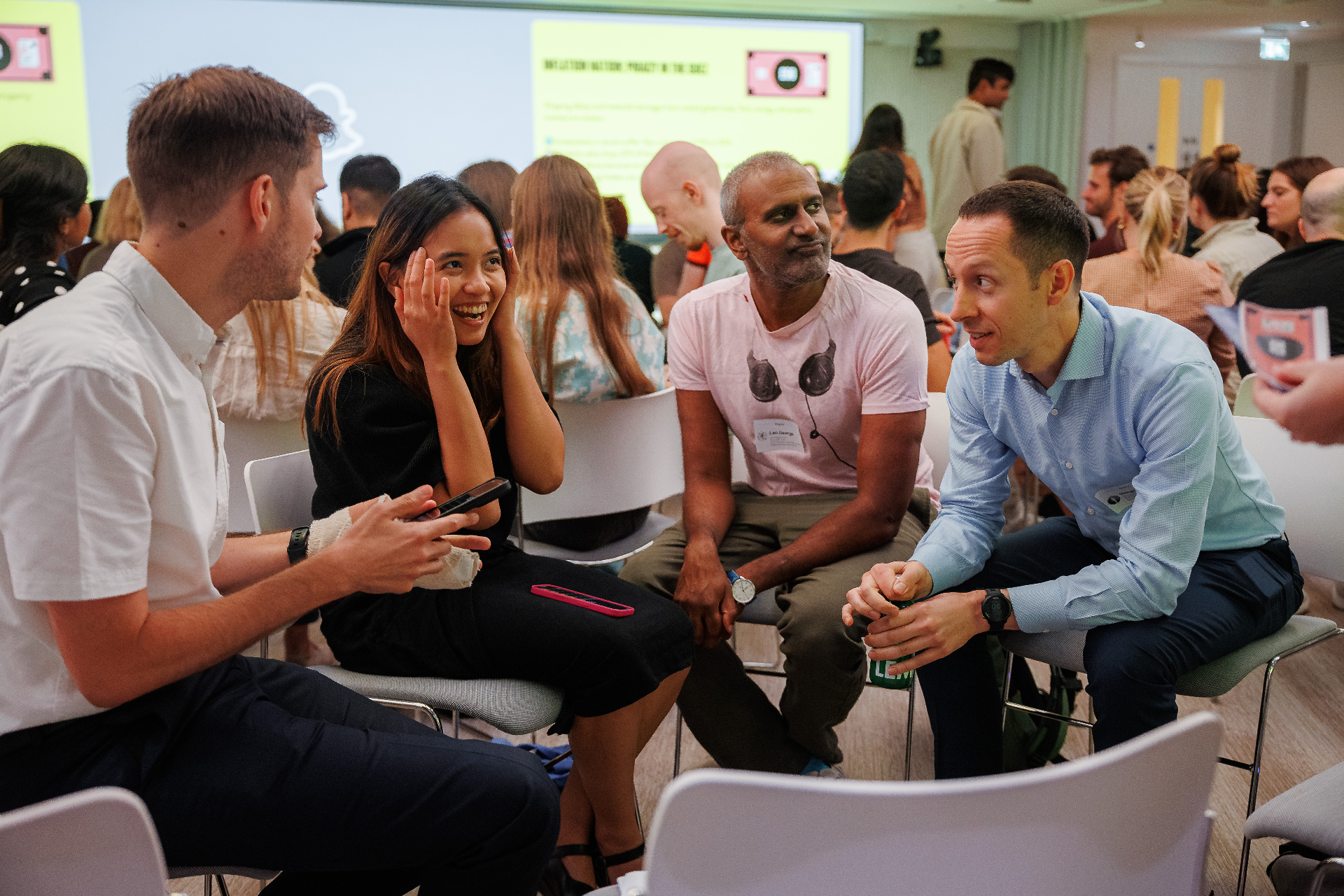 Four Rebel Book Club members deep in conversation between chairs