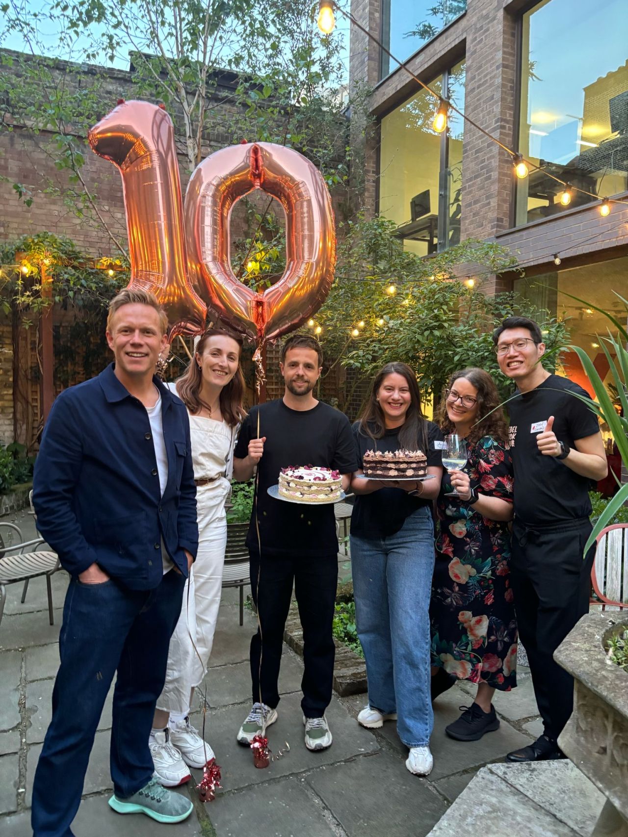 Rebel Book Club 10-year anniversary with cake and balloons