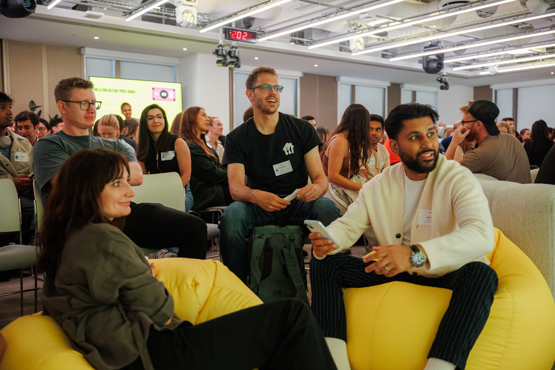 Rebel Book Club members laughing on yellow beanbags during a London event