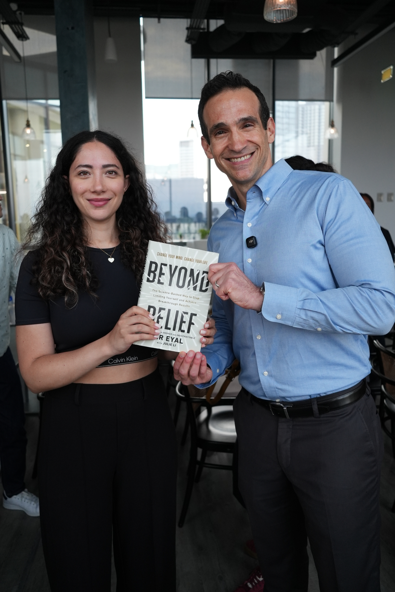 Rebel Book Club member with author Nir Eyal holding Beyond Belief